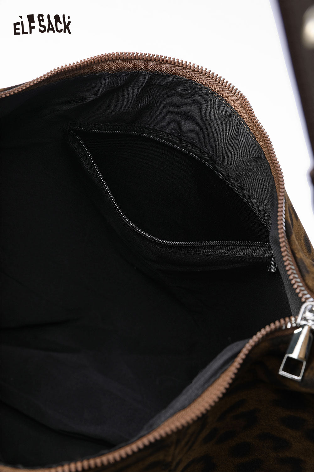 Interior view of leopard print suede crossbody bag featuring a zippered pocket and ample storage space