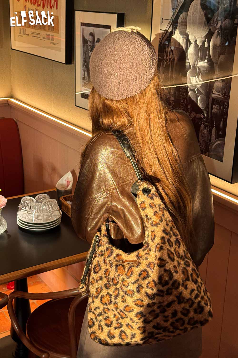 ELFSACK leopard print tote bag worn casually with a stylish brown leather jacket