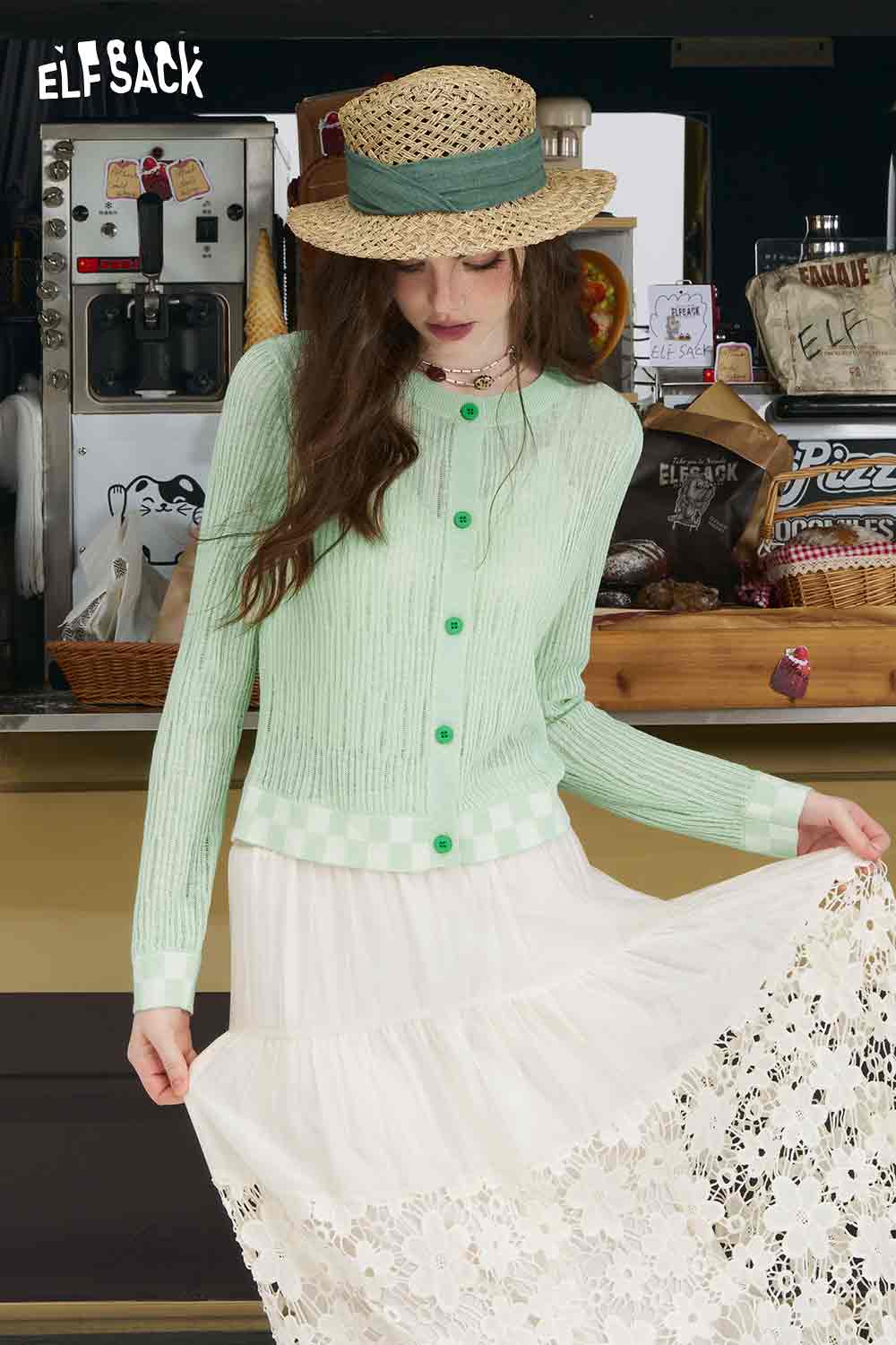 ELFSACK model wearing mint checkered knit cardigan with green buttons ribbed texture paired with white lace skirt and straw hat