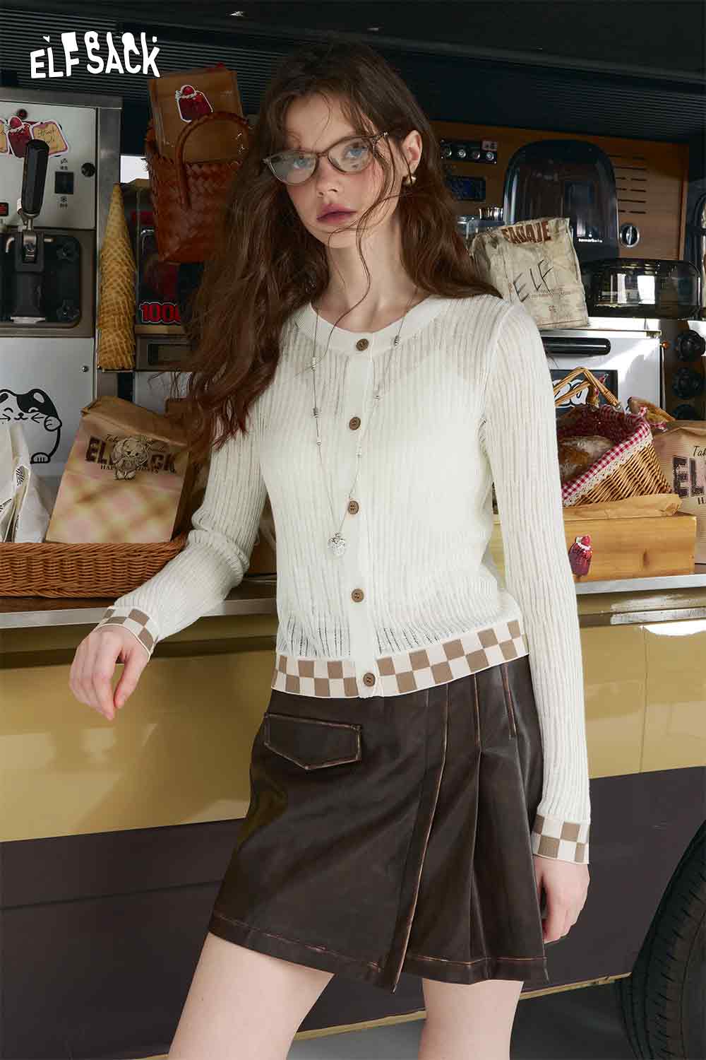 ELFSACK mint checkered knit cardigan on model white ribbed knit with button front and checkered hem