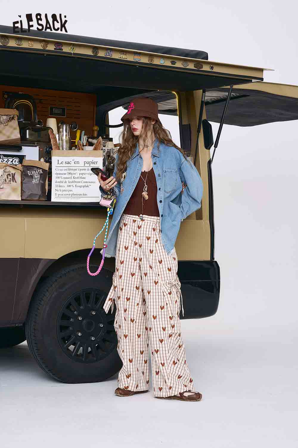 ELFSACK model wearing 3D mushroom denim shirt for women paired with brown tank and patterned wide pants