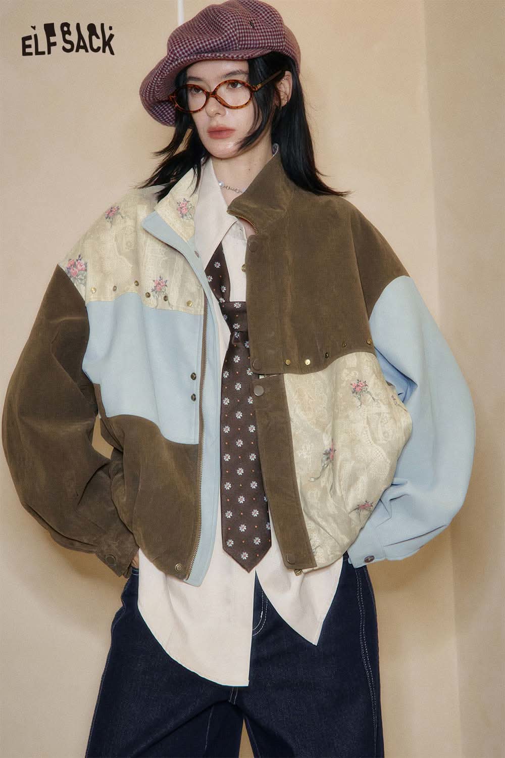 ELFSACK jacket featuring a unique patchwork design, layered over a lyocell blend semi-sheer knit top