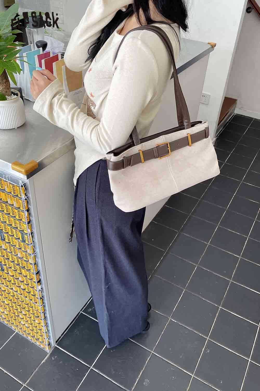 ELFSACK microsuede crossbody bag in pink, stylishly worn with casual outfit, perfect for everyday use.