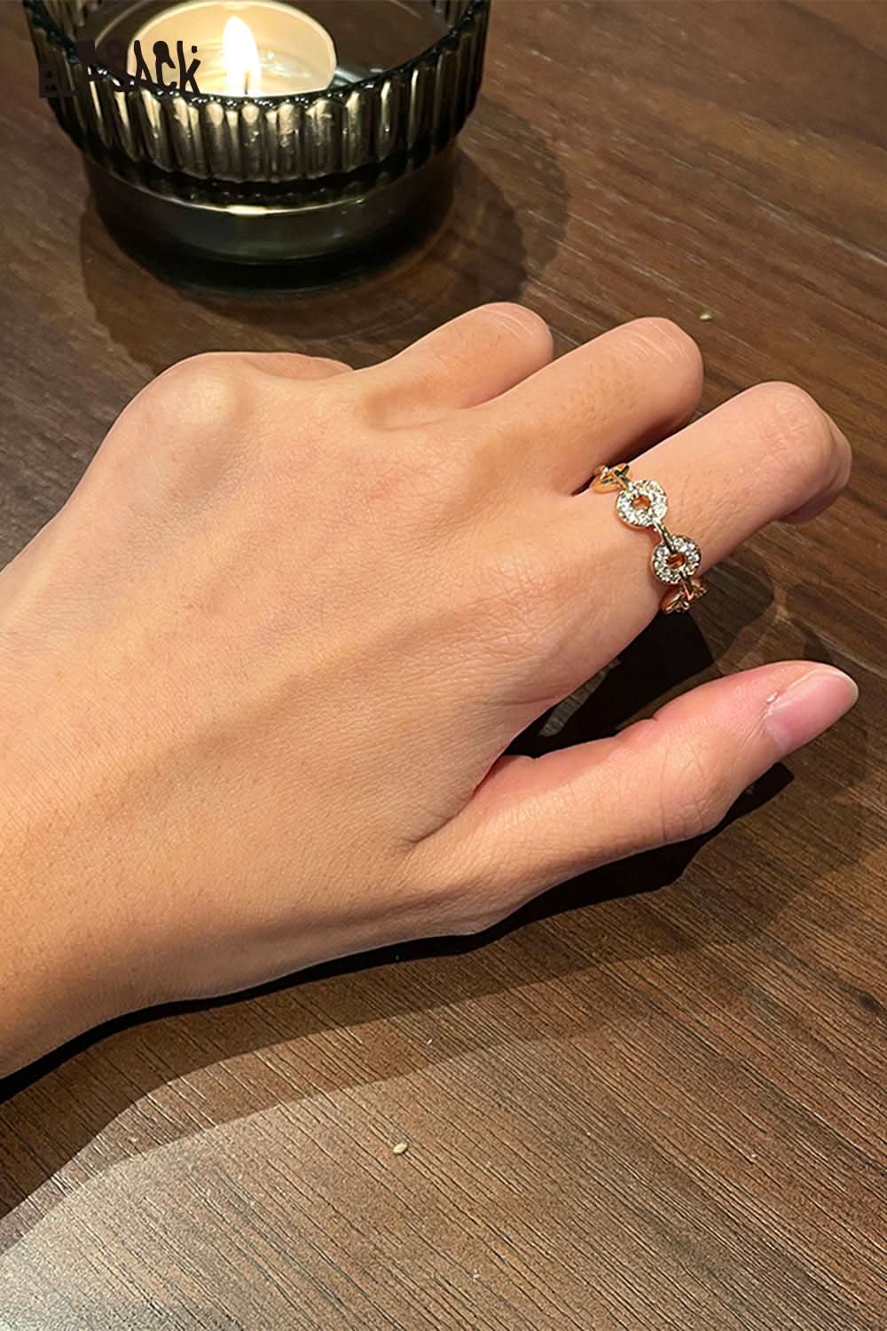 Elegant hand wearing a minimalist copper coin ring featuring intricate details and shine