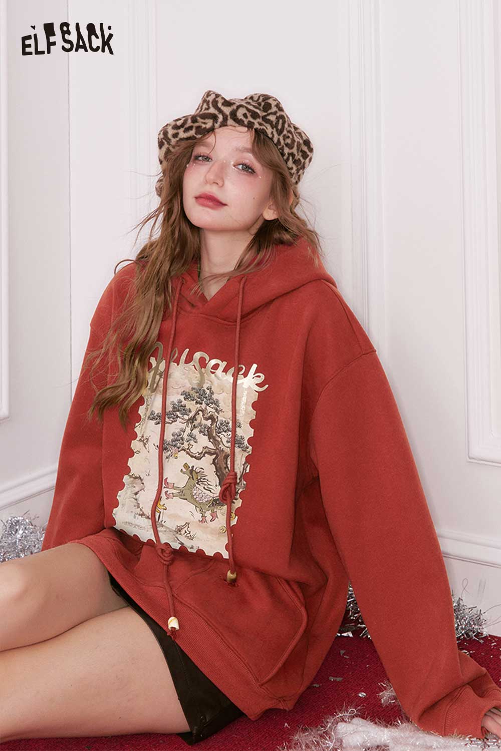 ELFSACK minimalist graphic hooded sweatshirt in red with artistic design and drawstring details