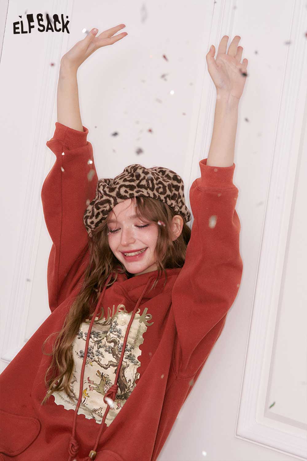 ELFSACK minimalist graphic hooded sweatshirt in rust color featuring a stylish design and cozy fit