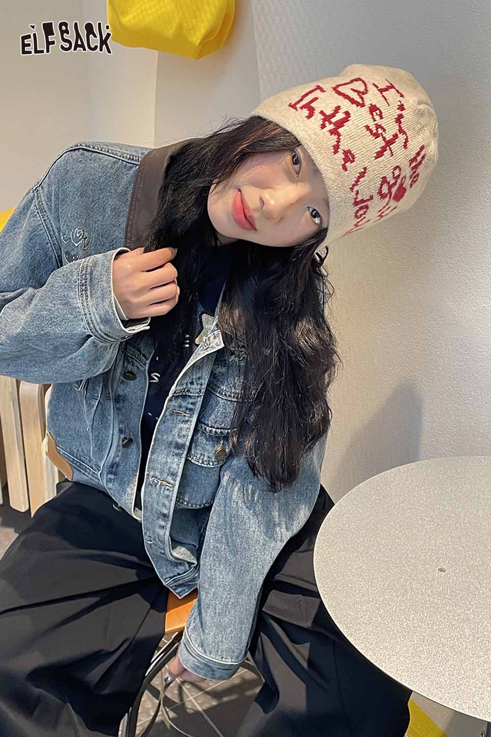 Stylish minimalist letter graphic beanie in cream featuring bold red text for a trendy look