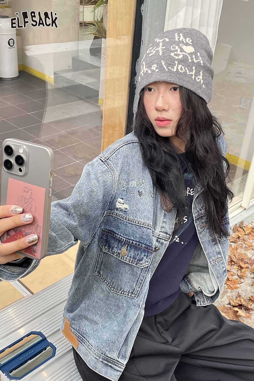 Stylish woman wearing a minimalist letter graphic beanie with a denim jacket, perfect for casual outfits