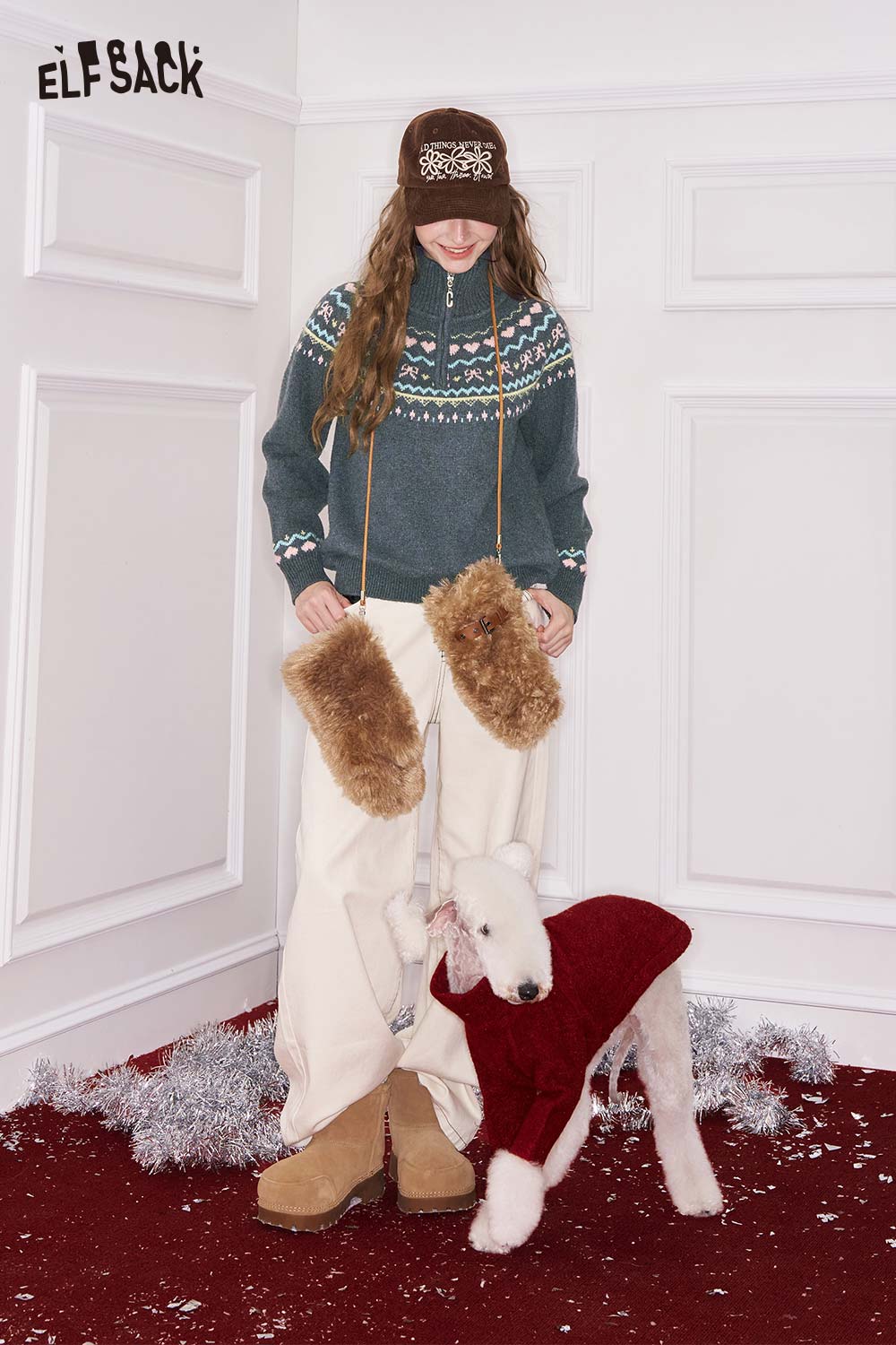 ELFSACK minimalist stripe zipper sweater in blue with festive pattern worn by a model in winter attire