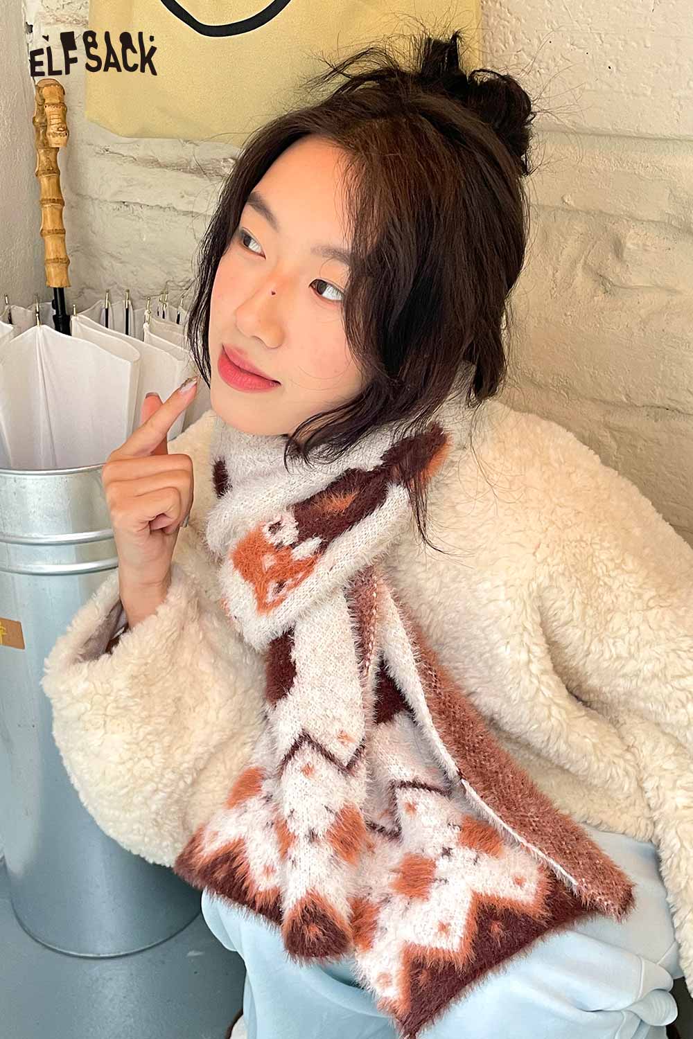 ELFSACK minimalist striped graphic scarf styled with a cozy white jacket, perfect for a chic look