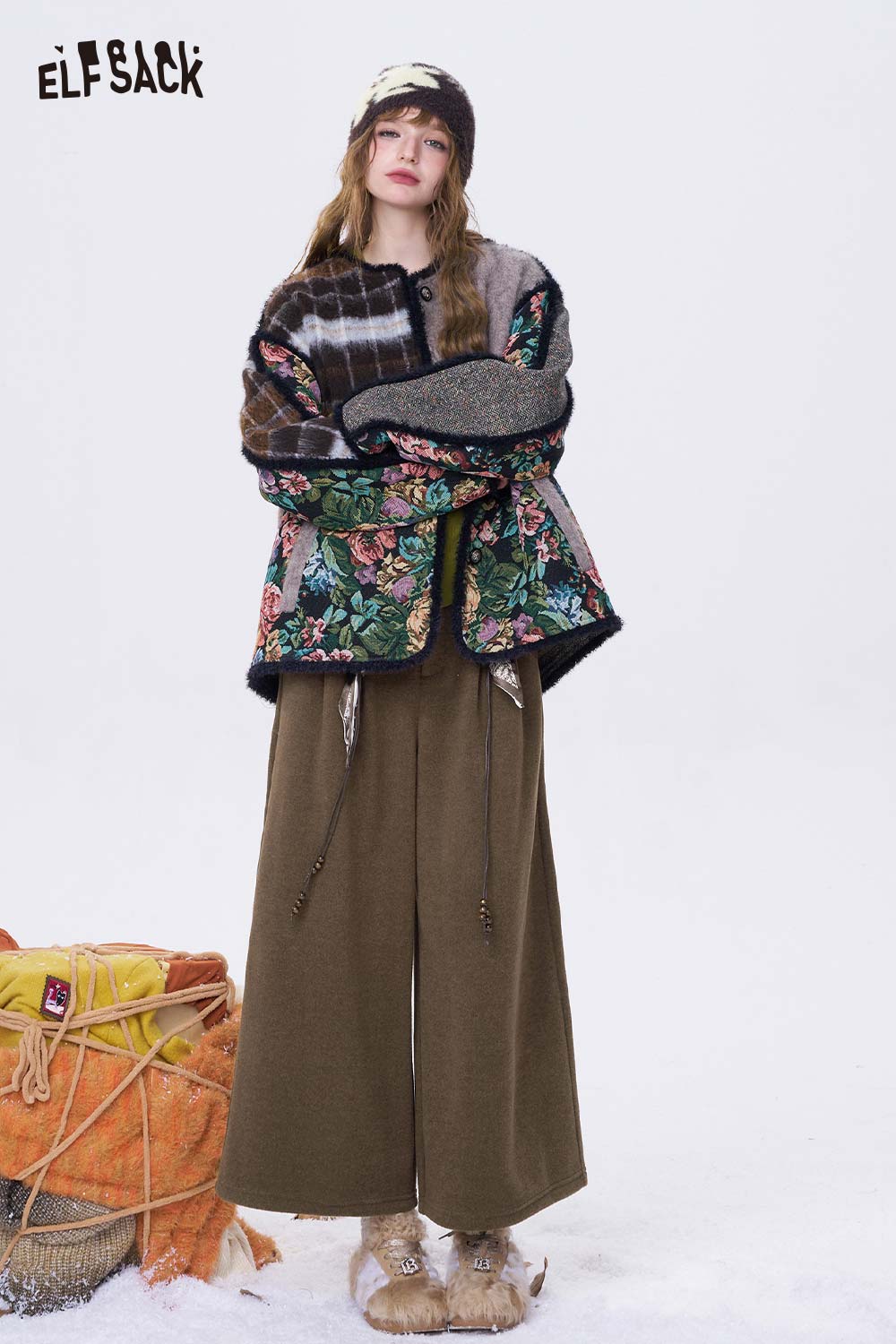 Woman wearing ELFSACK minimalist wide leg cropped pants styled with a floral jacket for a trendy look