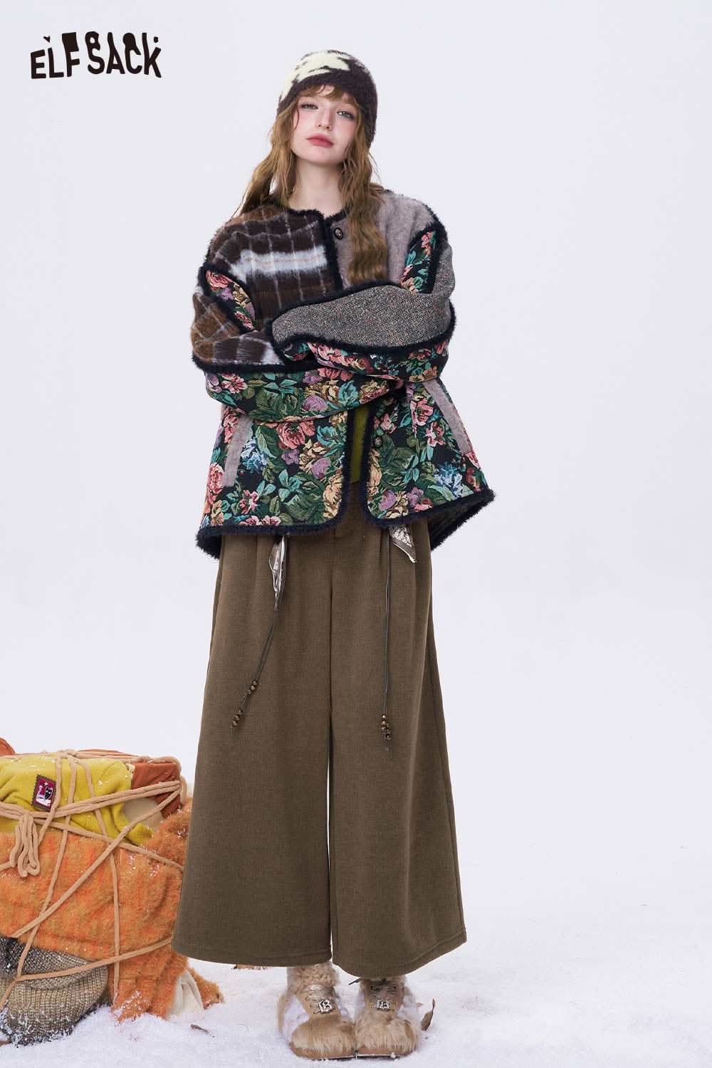 Woman wearing ELFSACK minimalist wide leg cropped pants styled with a floral jacket for a trendy look