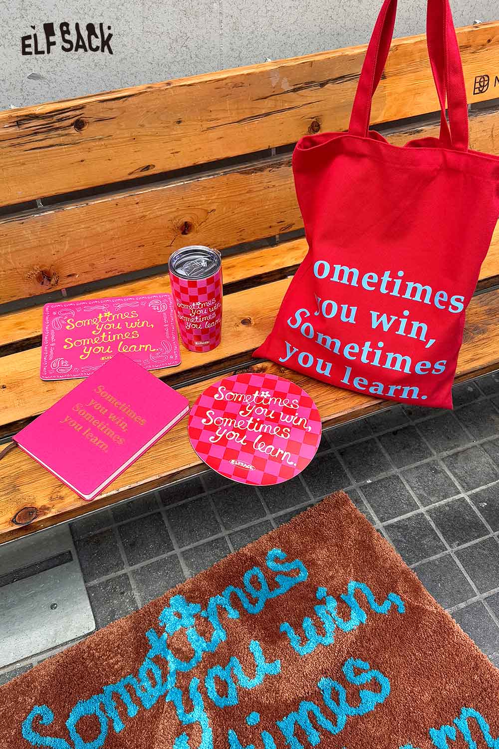 ELFSACK motivational quote hardcover notebook in pink with matching tote and accessories on a bench