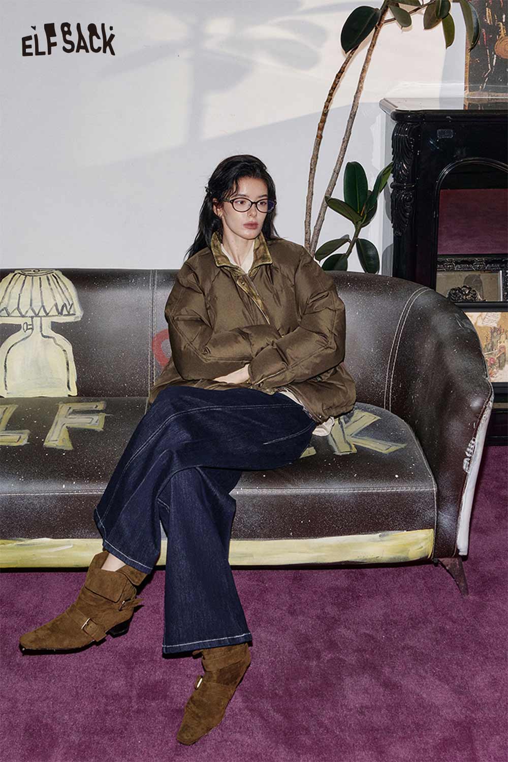 ELFSACK oversized quilted plaid coat featured on a model sitting on a stylish couch with denim pants