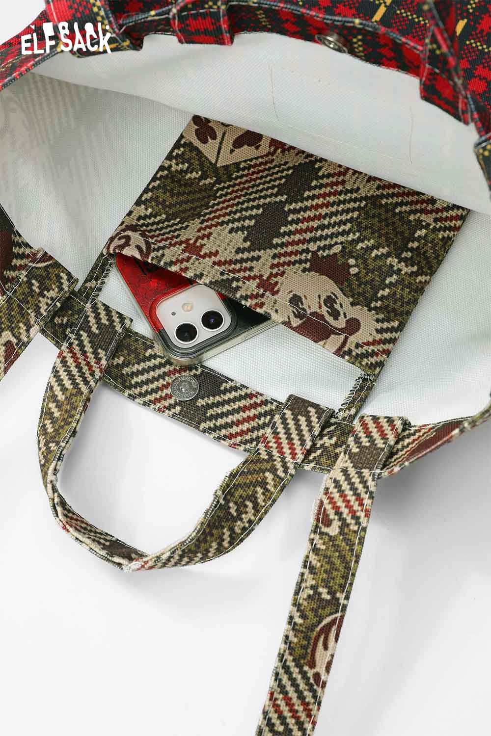 Interior view of ELFSACK plaid cartoon crossbody bag showing a phone and patterned pocket