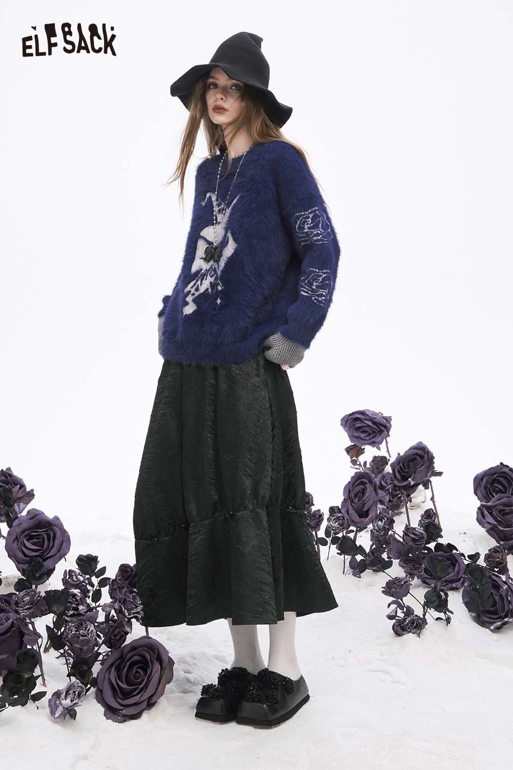 ELFSACK pleated A-line long skirt in dark fabric paired with a cozy sweater and hat
