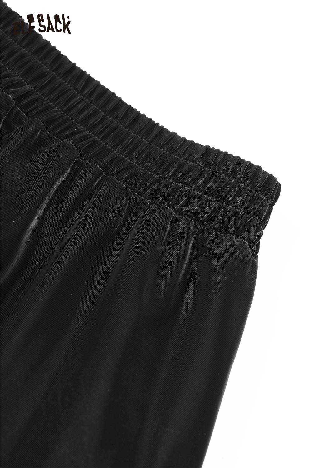 Close-up of ELFSACK pleated PU leather maxi skirt showing elastic waistband and sleek texture