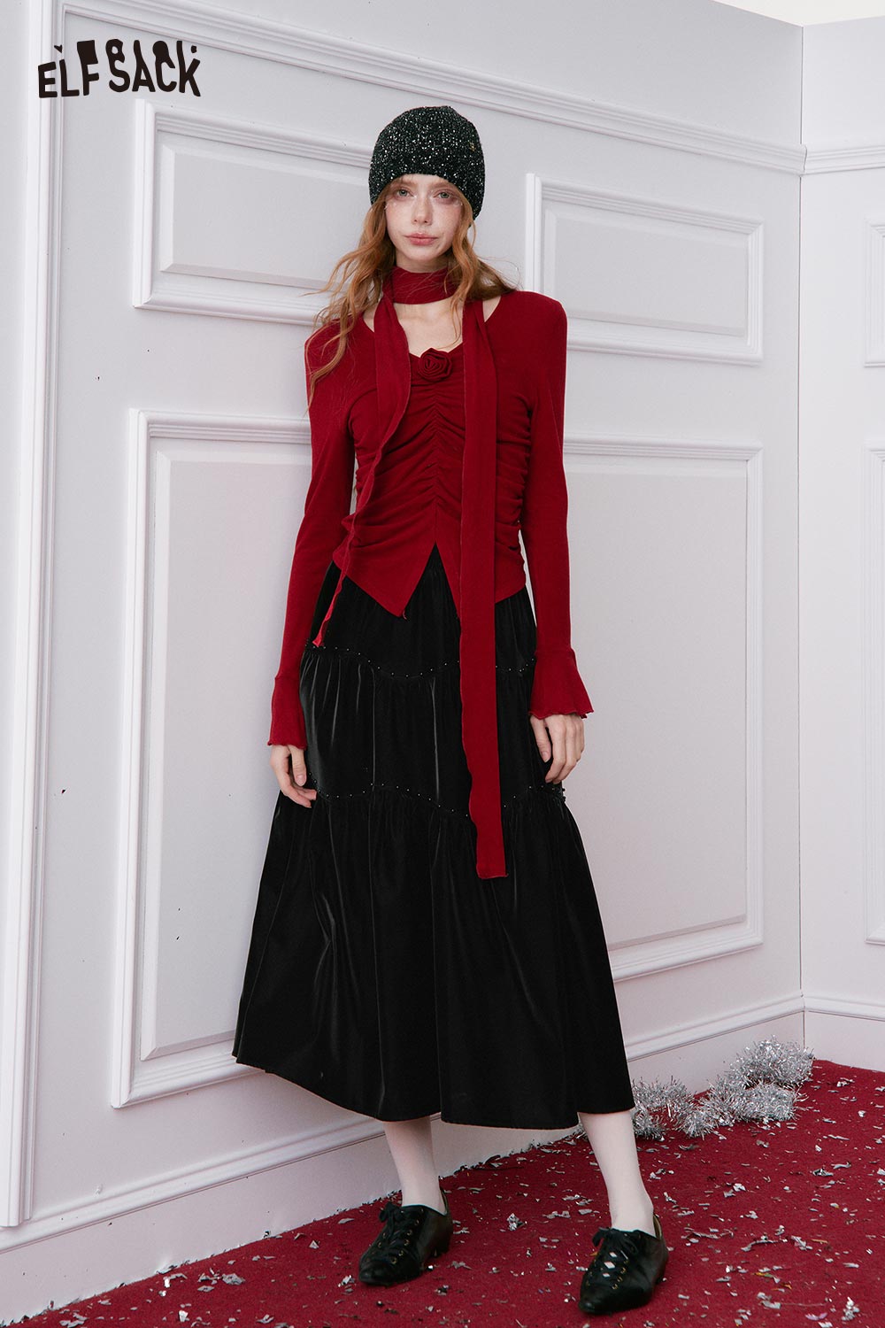 Stylish woman wearing a red top with a pleated PU leather maxi skirt for a fashionable look