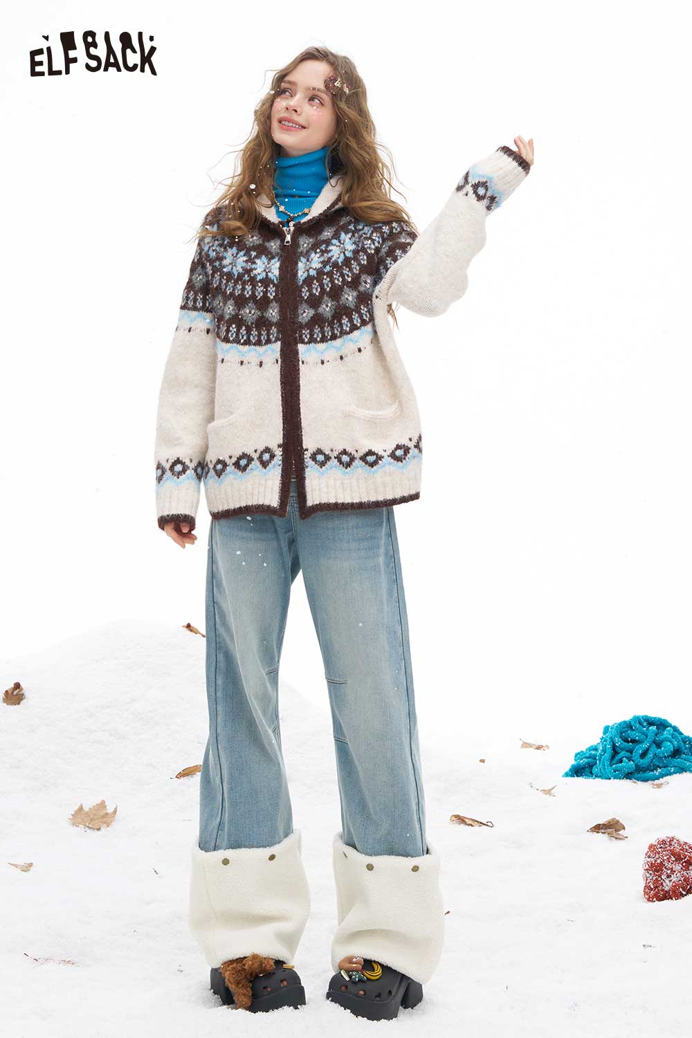 ELFSACK plush hem patchwork jeans styled with a cozy knit sweater in a winter snowy setting