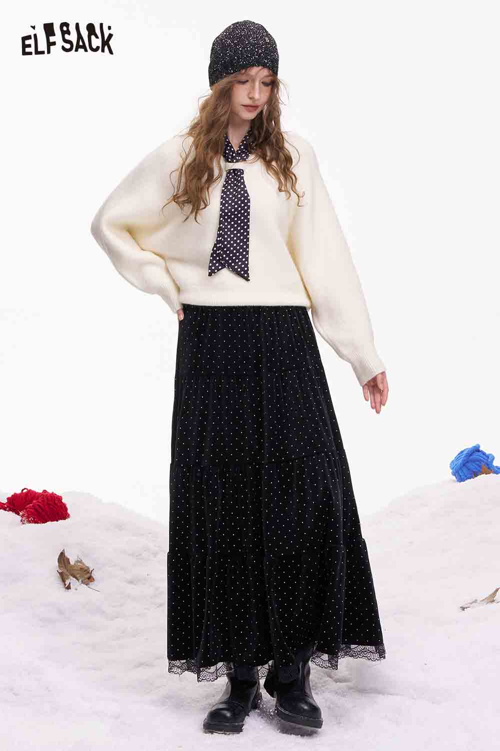 ELFSACK polka dot lace ruffle skirt styled with a cozy sweater and hat for a chic winter look