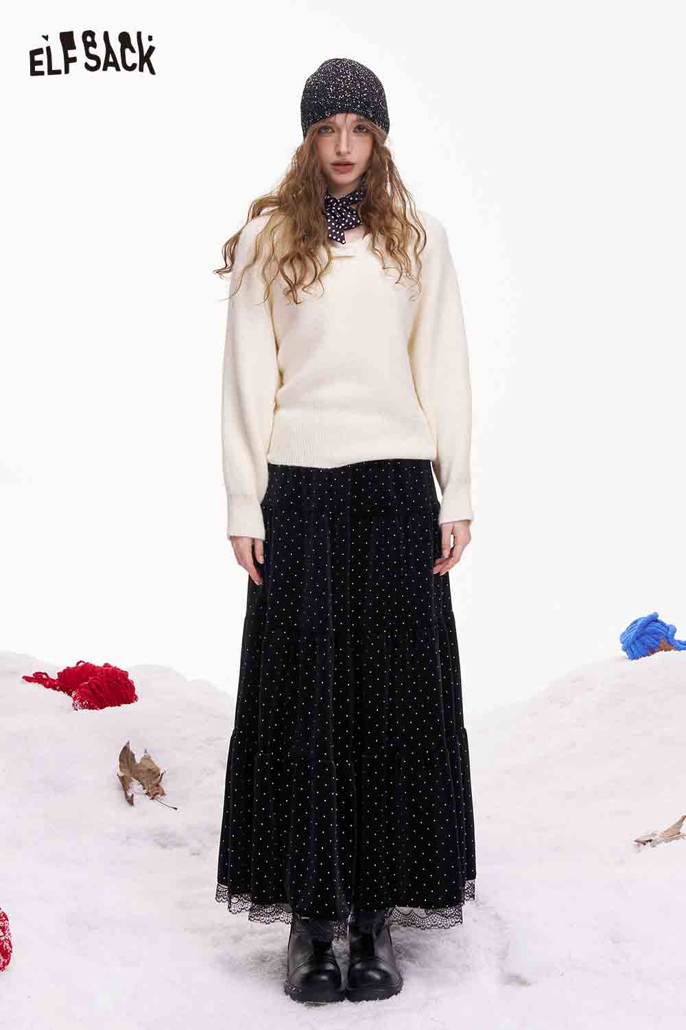 ELFSACK polka dot lace ruffle skirt in black paired with a cozy sweater for a stylish winter outfit