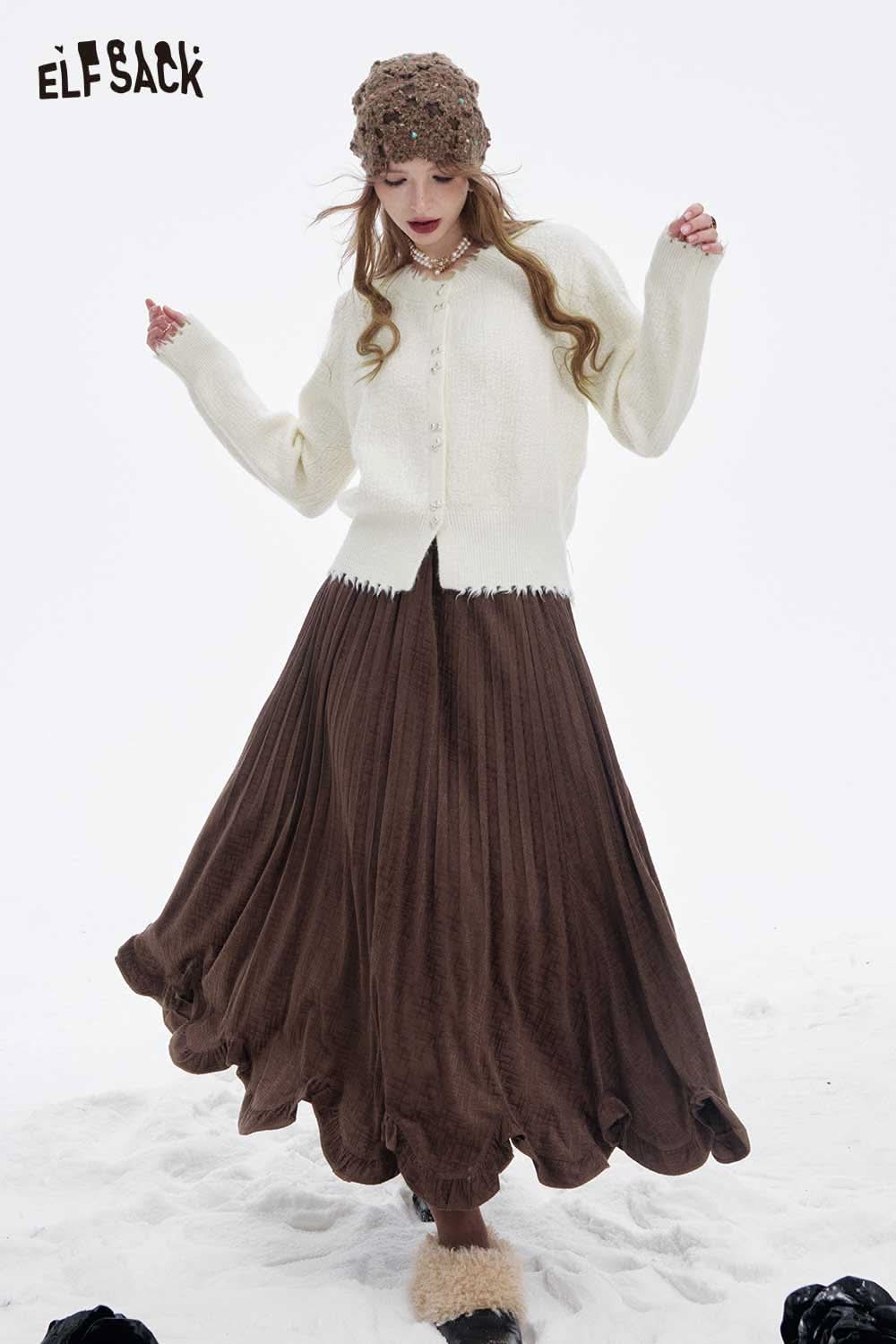 ELFSACK preppy fringe sweater for women paired with a stylish brown pleated skirt in a snowy setting
