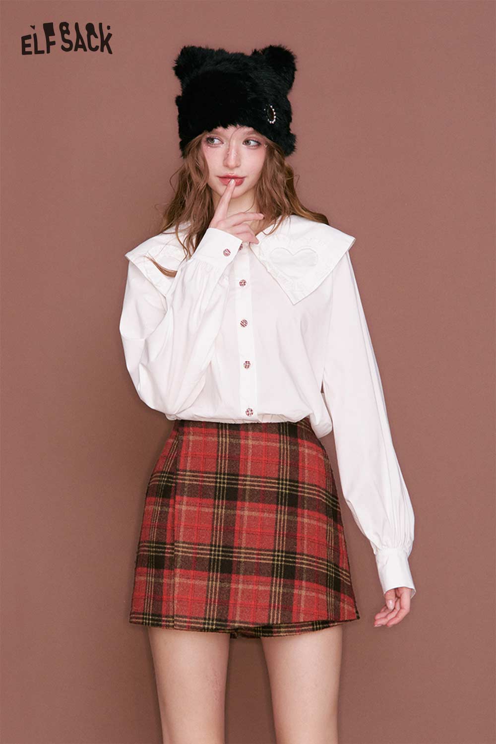 ELFSACK model wearing a preppy red plaid culottes skirt paired with a white button-up top