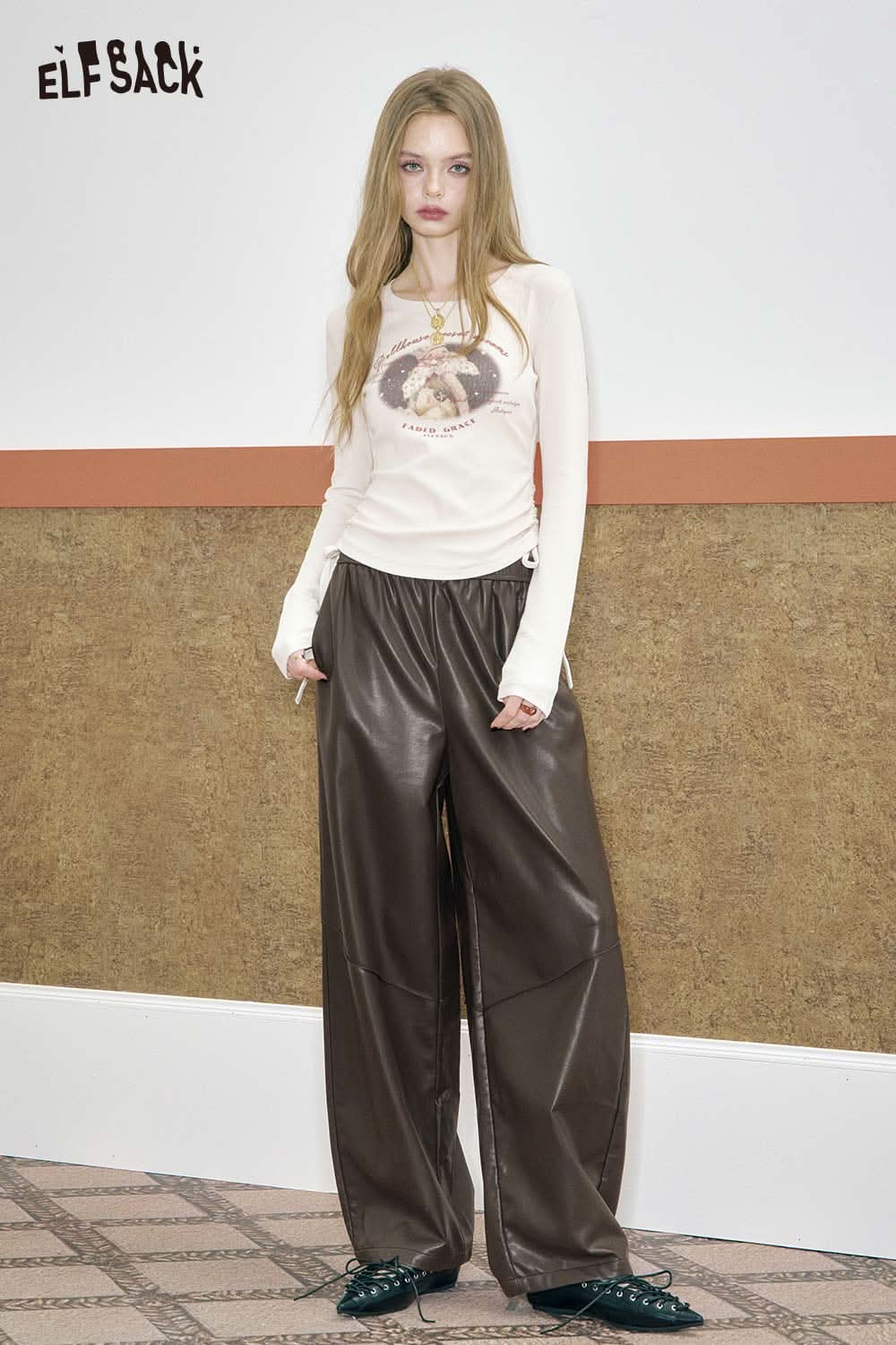 ELFSACK PU leather relaxed fit trousers in brown paired with a graphic long sleeve top for a trendy look