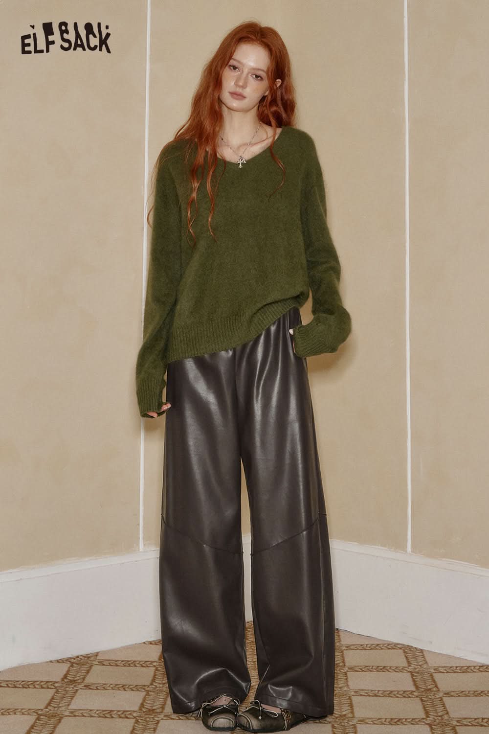 ELFSACK PU leather relaxed fit trousers in dark gray paired with a cozy green sweater