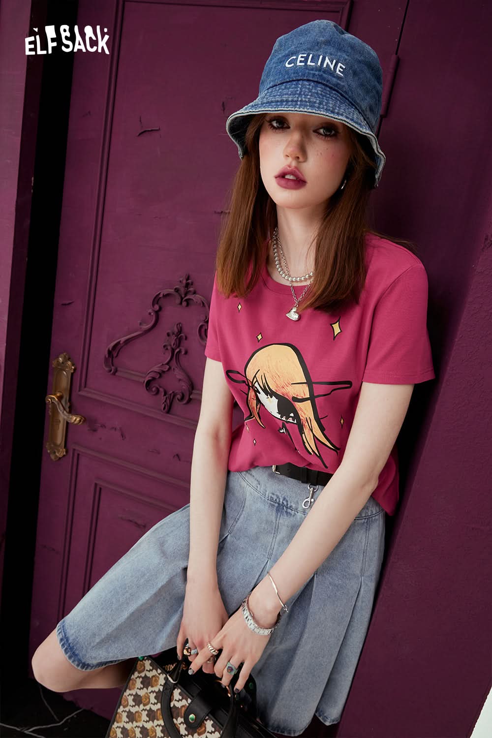 ELFSACK punk style pink graphic T-shirt worn with denim skirt and blue bucket hat