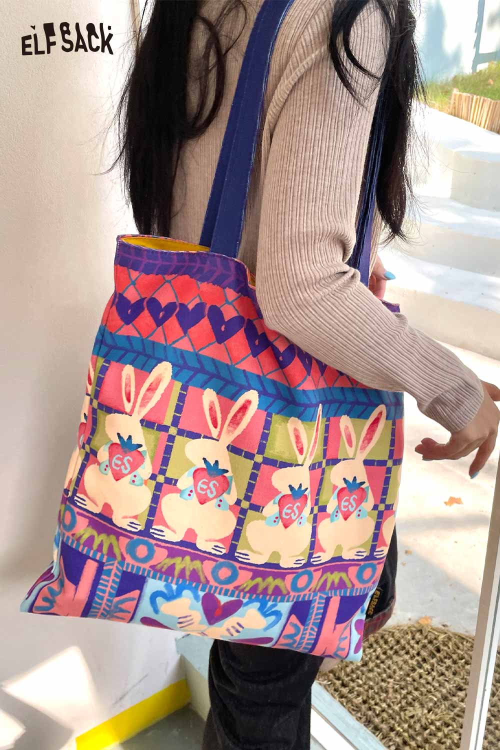 Colorful rabbit graphic tote bag by ELFSACK featuring playful bunny designs and sturdy straps
