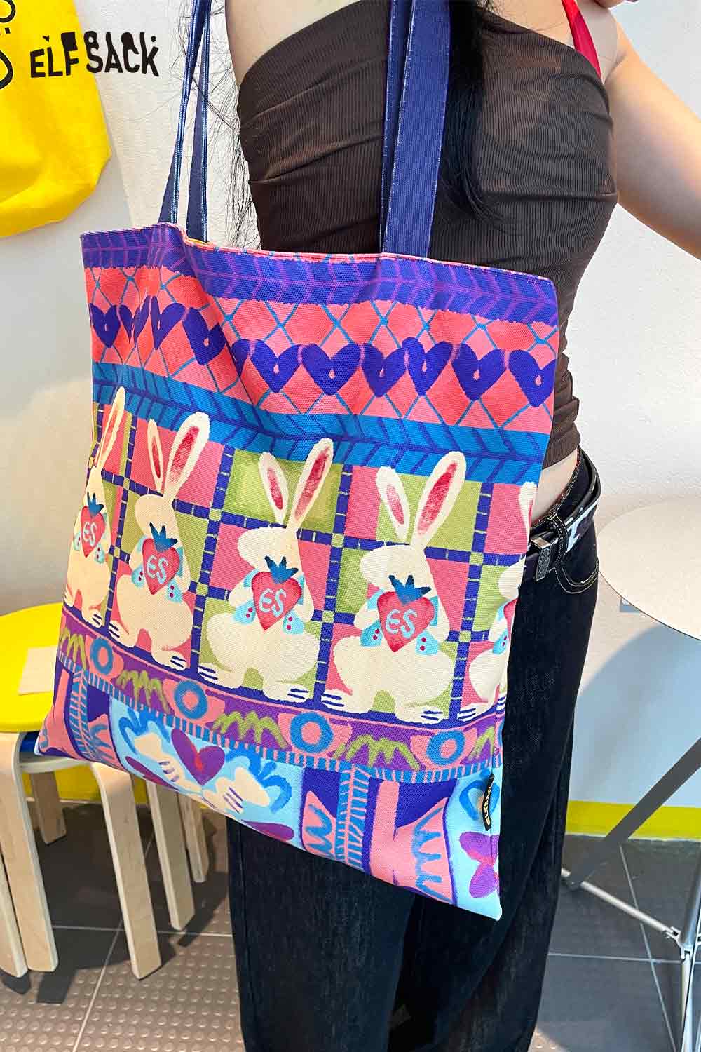 Colorful ELFSACK rabbit graphic tote bag featuring playful bunny designs and vibrant patterns
