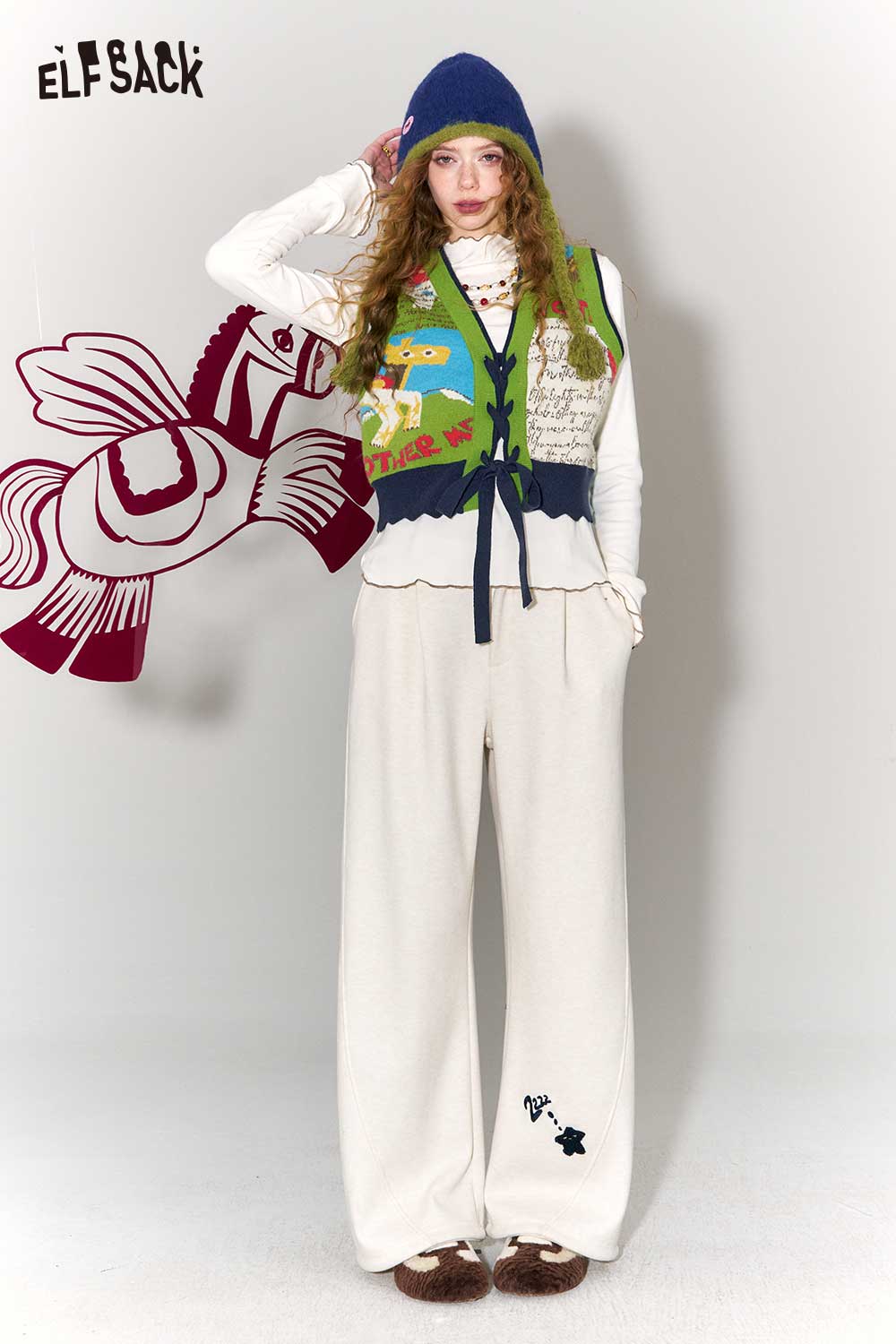 ELFSACK retro denim knit vest for women styled over a white top and cozy pants for a trendy look