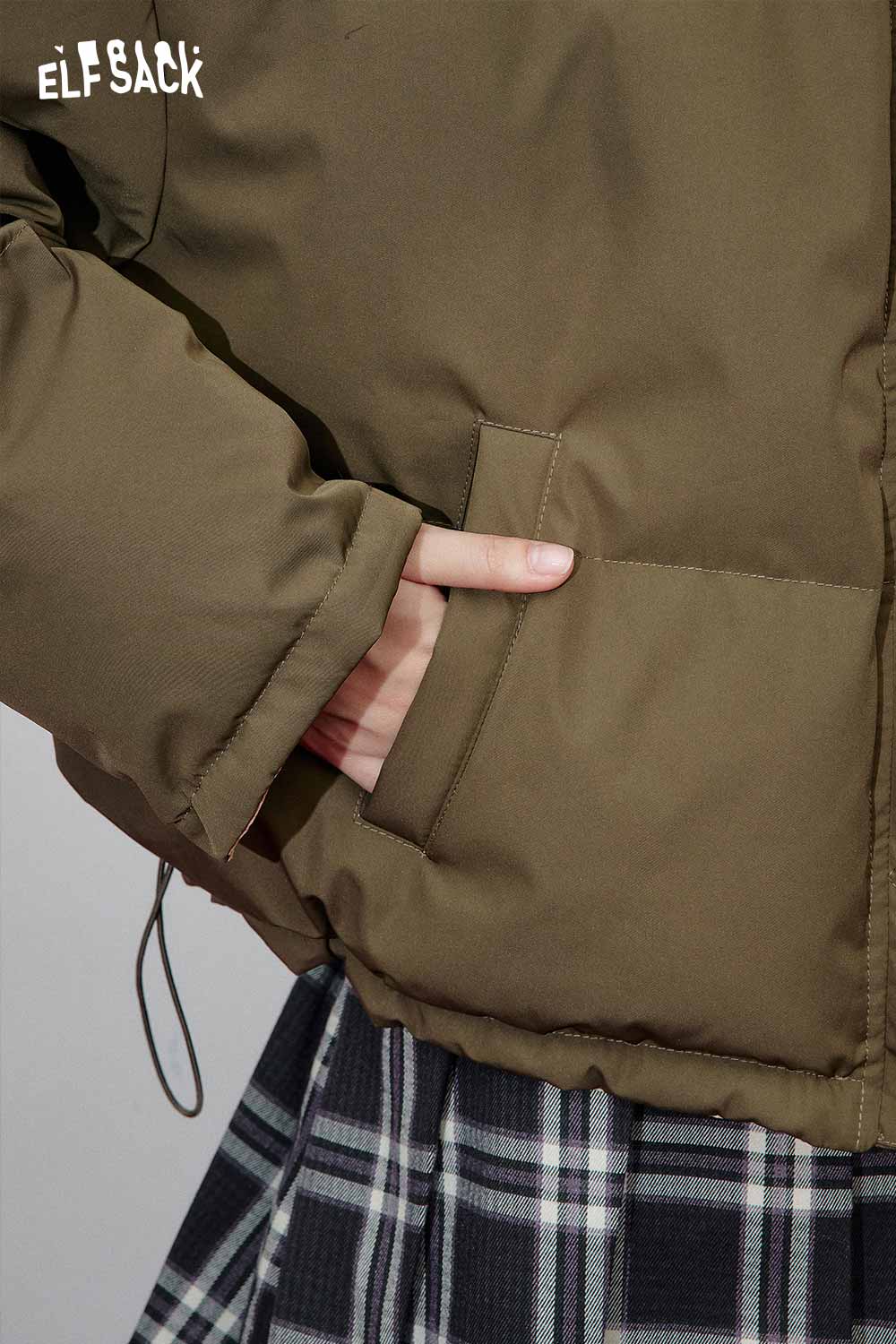 Close-up of ELFSACK reversible cartoon graphic puffer coat showcasing its pockets and warm design