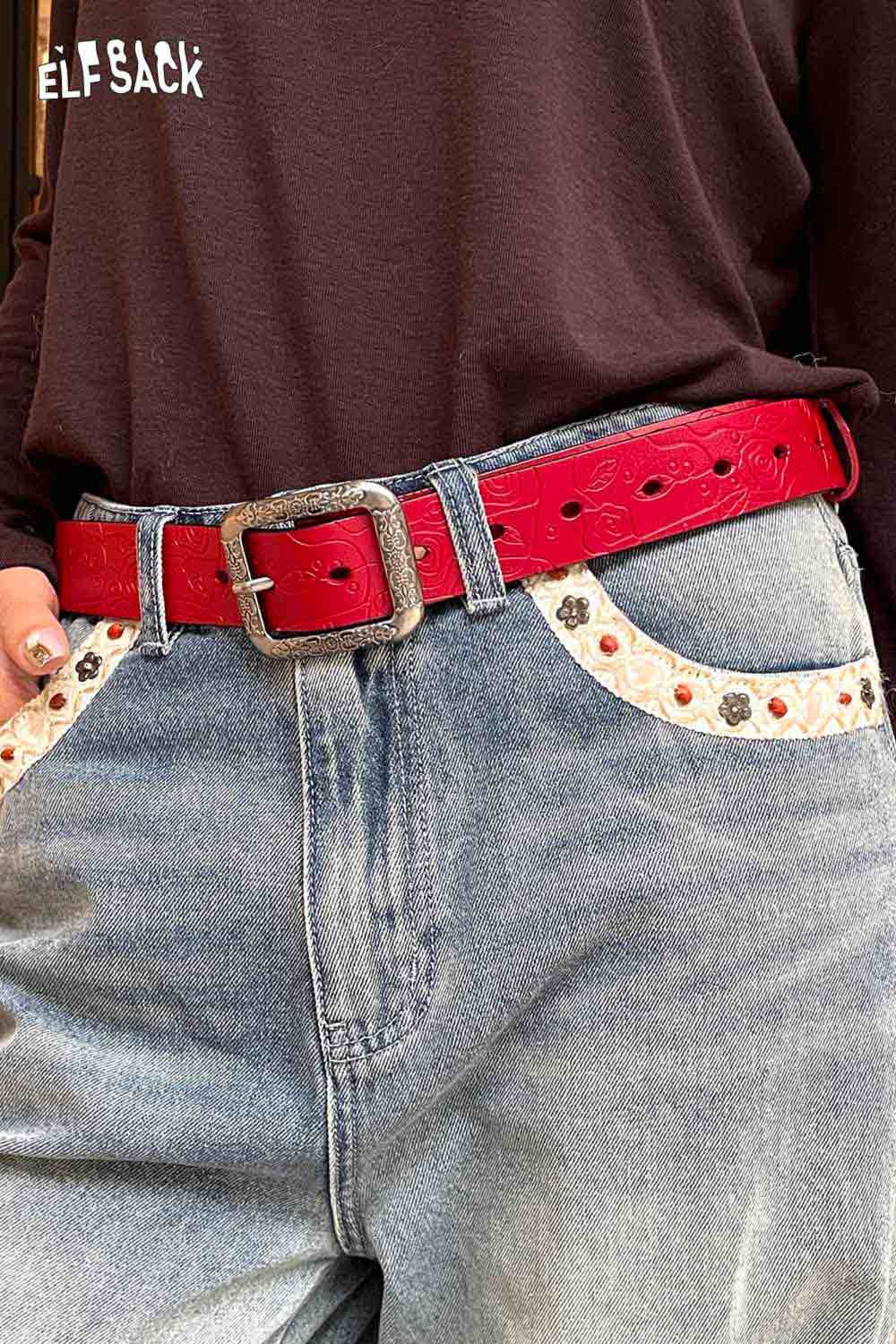 ELFSACK reversible rose pattern belt in red, styled with denim jeans for a trendy look
