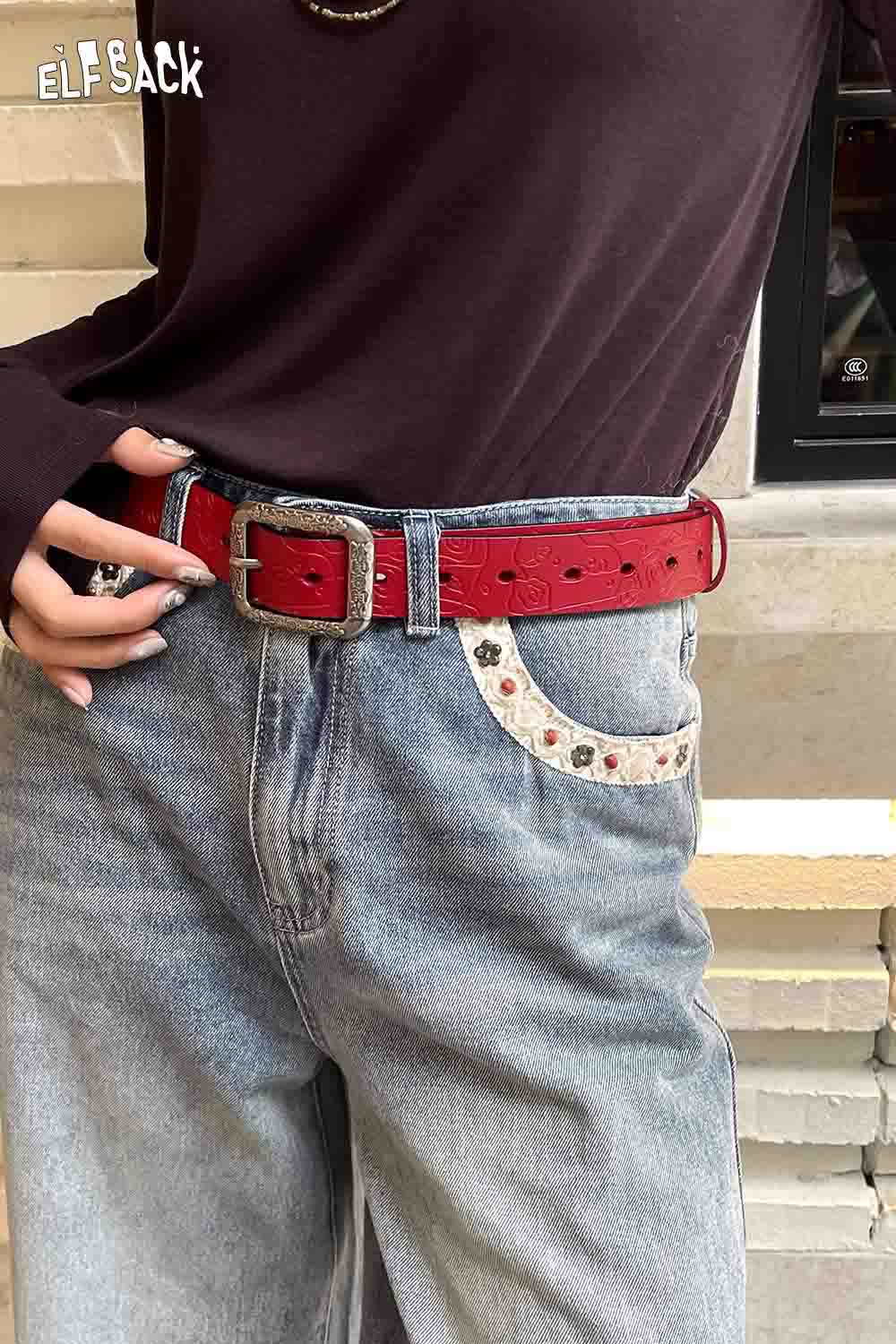 ELFSACK reversible rose pattern belt in red showcased with denim jeans for a stylish look