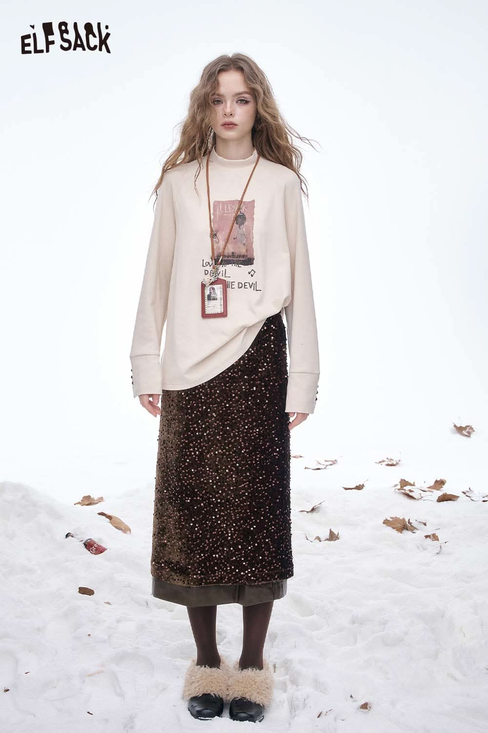 ELFSACK sequin faux leather long skirt paired with a graphic sweatshirt for a stylish look