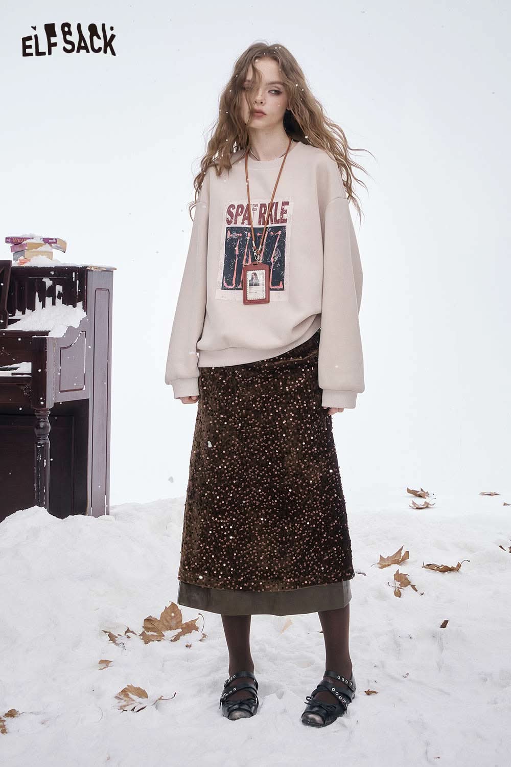 ELFSACK sequin faux leather long skirt with a stylish design, paired with cozy sweatshirt for a trendy winter look