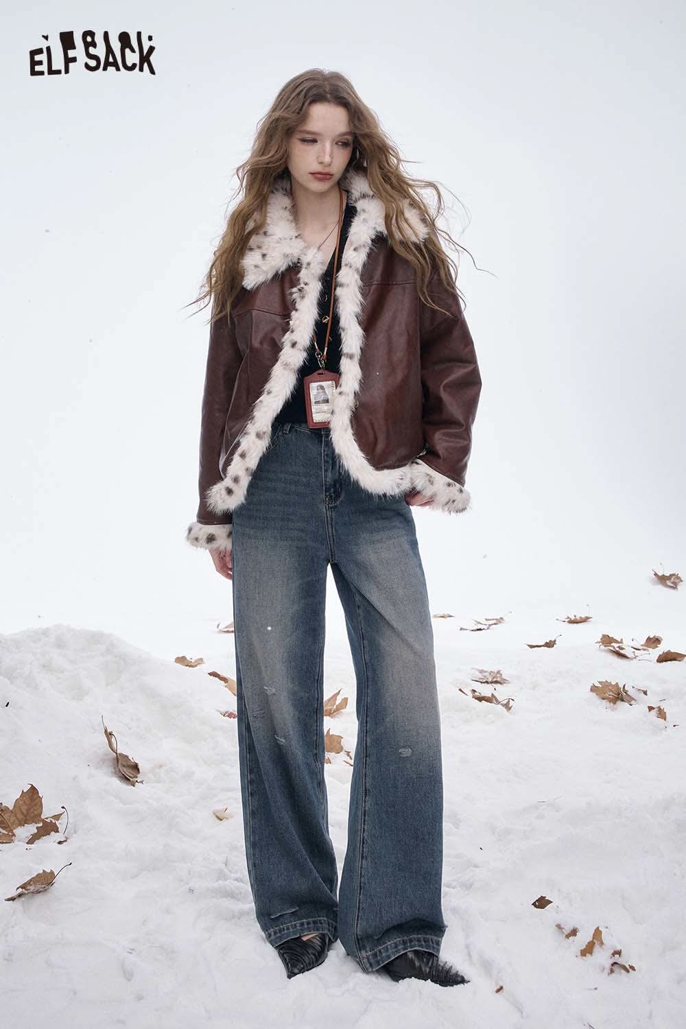 Model wearing a slim fit V neck knit sweater under a brown leather jacket in a snowy setting