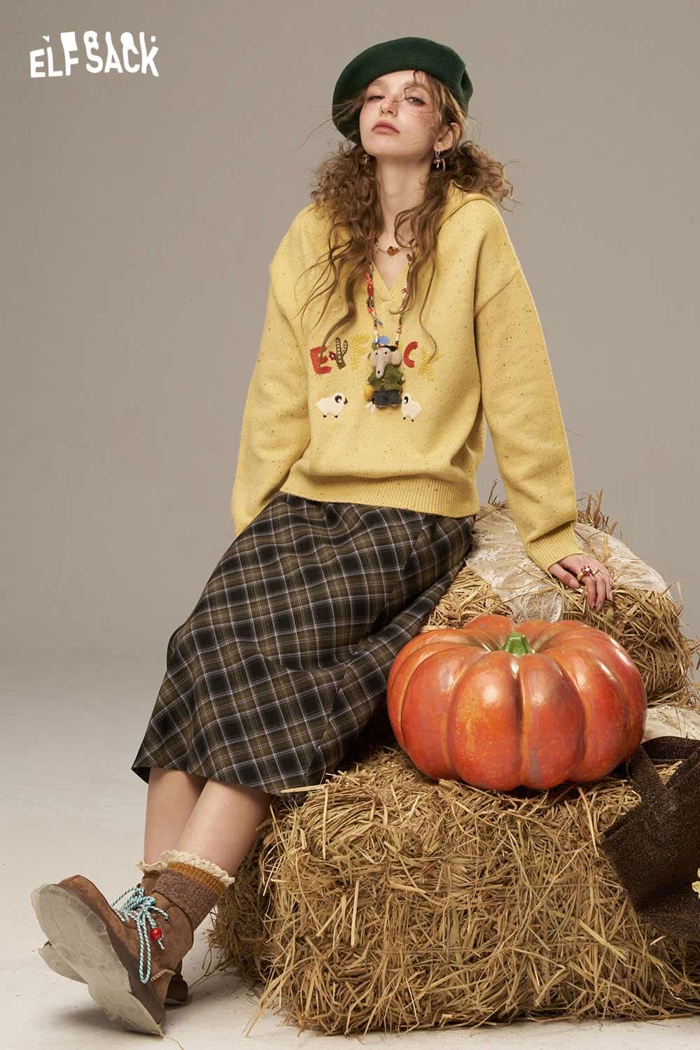 Cute cartoon sheep sweater for women from ELFSACK styled with a plaid skirt and accessories