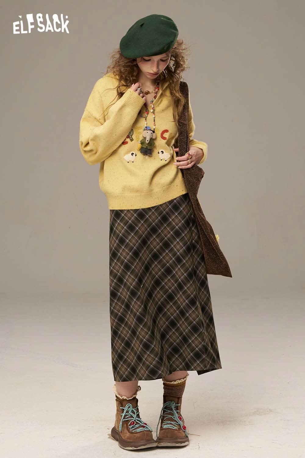 Cute cartoon sheep sweater for women in yellow, styled with a plaid skirt and accessories