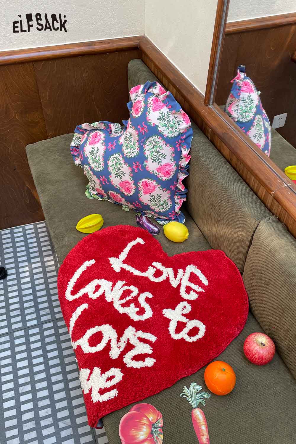ELFSACK red heart pillow with white script and navy floral heart shaped rose pillow on sofa