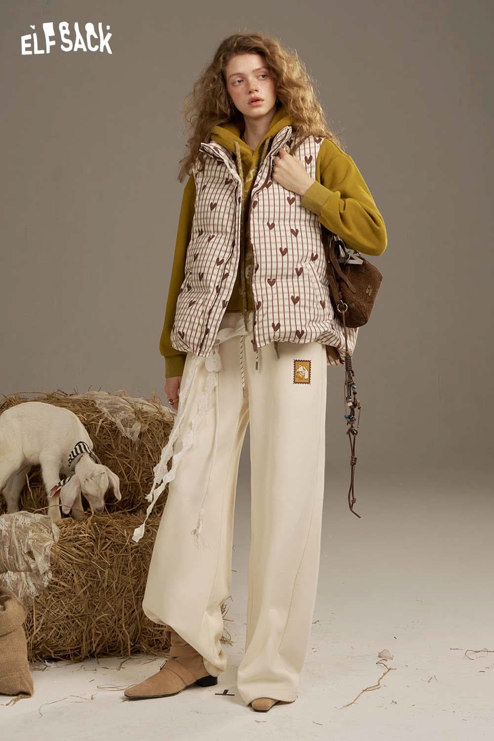 ELFSACK women's checkered down vest styled with a cozy outfit and set in a rustic environment