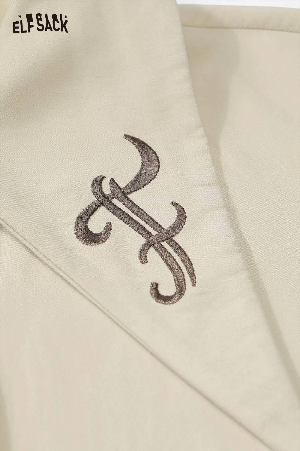 Close-up of ELFSACK women's soft lapel collar shirt featuring an elegant embroidered design
