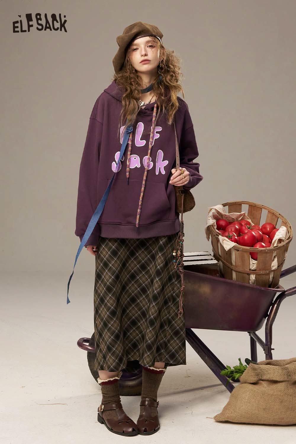 Women's letter print sweatshirt by ELFSACK, featuring a bold design in purple color, styled with a skirt