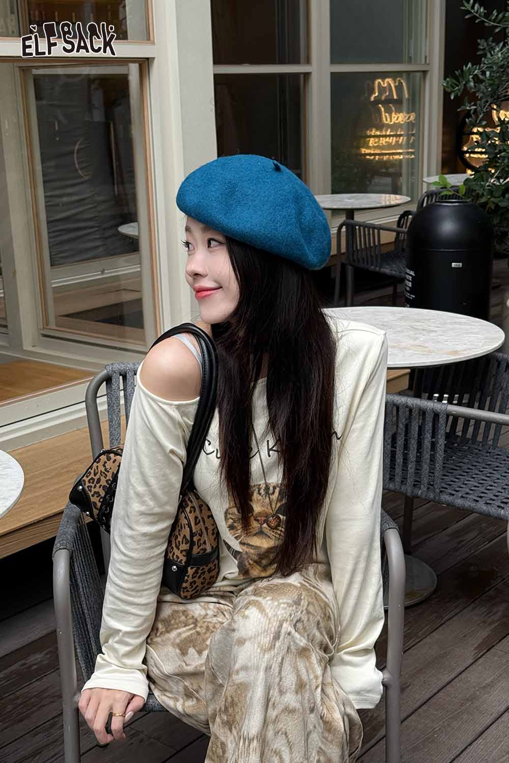 Stylish woman wearing a soft pumpkin beanie for women with casual outfit in a cozy cafe setting