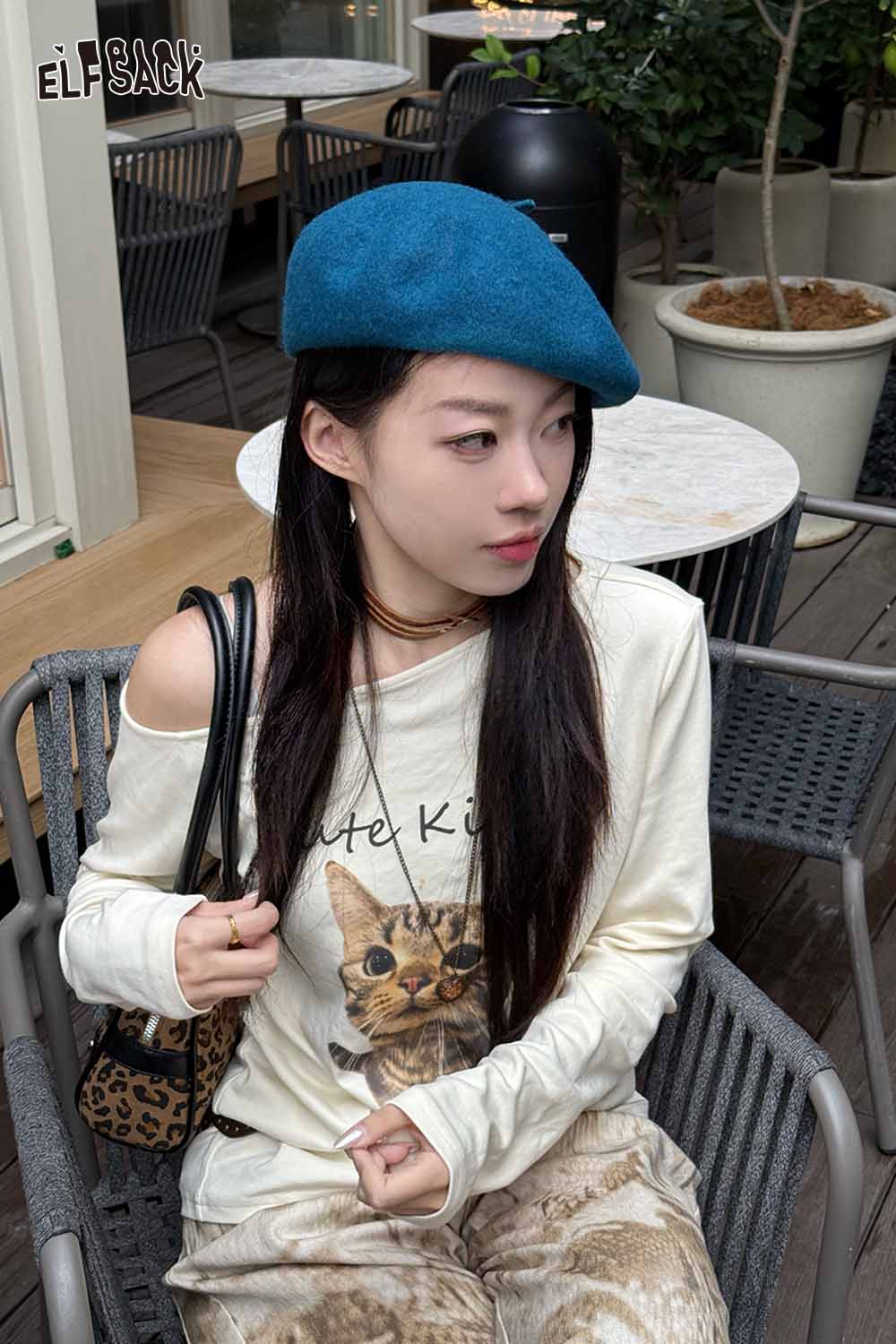 Stylish ELFSACK soft pumpkin beanie for women worn with a casual outfit and cat graphic long sleeve shirt
