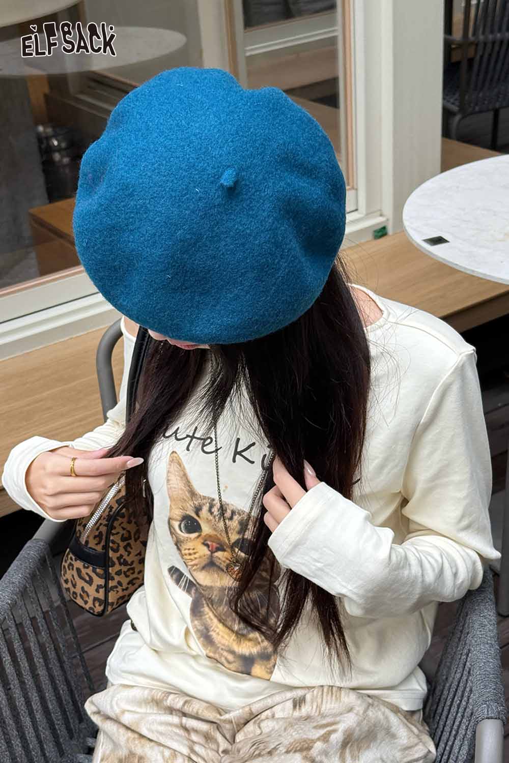 ELFSACK soft pumpkin beanie for women in blue paired with a casual cat print top