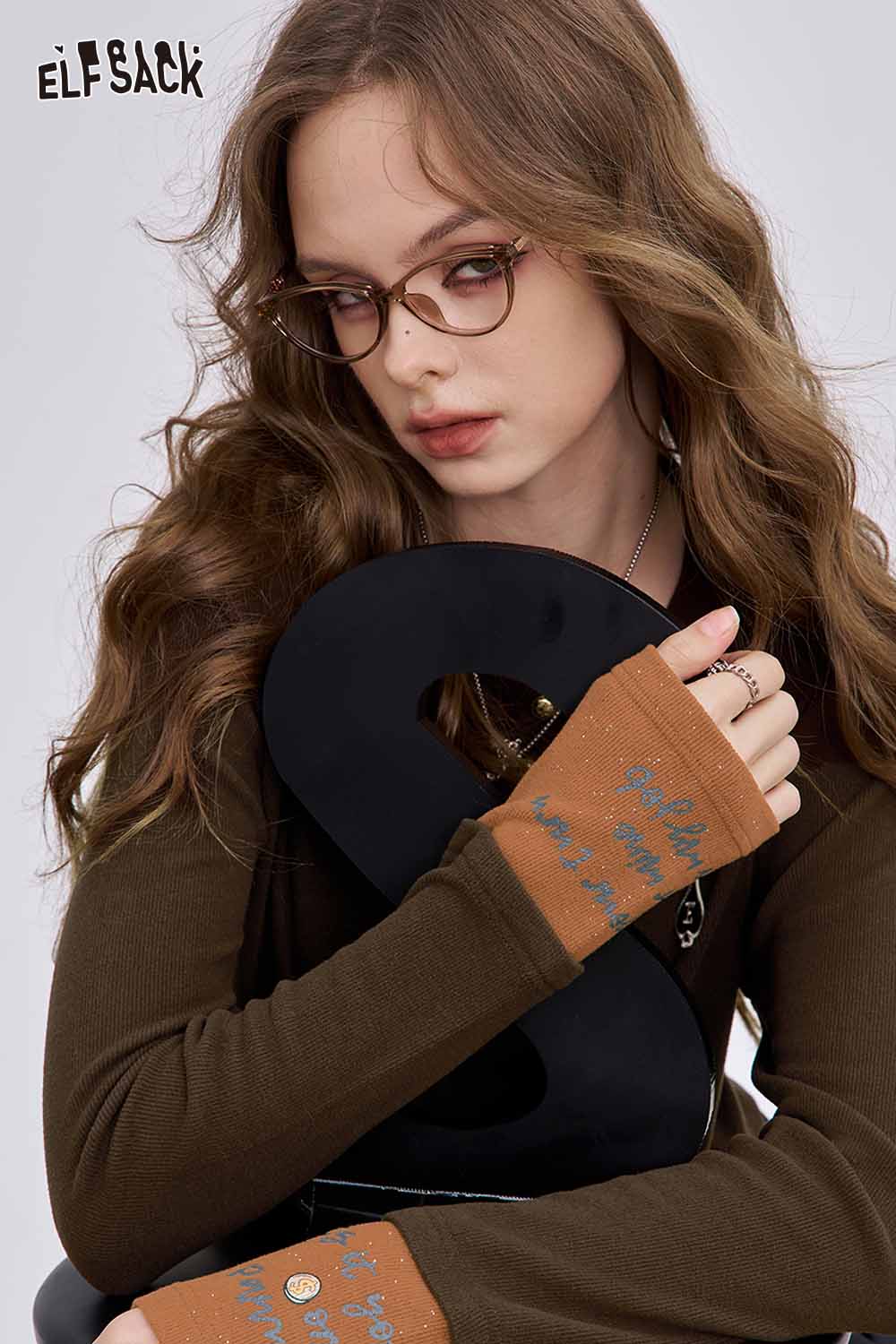 ELFSACK soft spliced sleeve long sleeve tshirt featuring a stylish design and playful text on sleeves