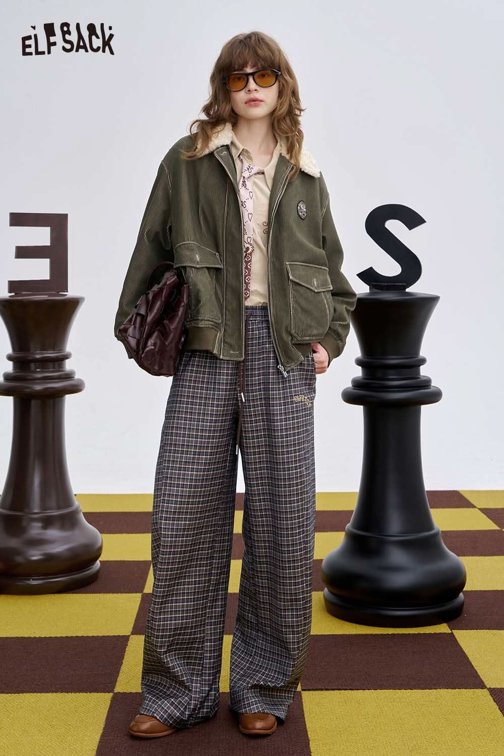 Model wearing ELFSACK soft stripe embroidered wide leg pants styled with a jacket and accessories